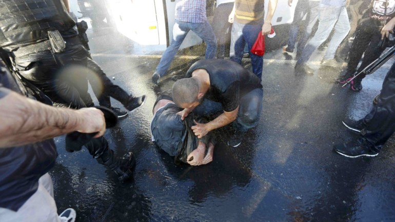 A civilian beats a soldier after troops involved in the coup surrendered on the Bosphorus Bridge in Istanbul