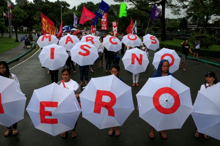 Protesters display umbrellas spelling out "Marcos is no Hero" as they join hundreds of protesters denouncing the planned burial of late dictator Ferdinand Marcos at the Libingan ng mga Bayani (Heroe''s