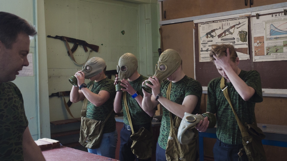 During military training at School No 58, older pupils learn how to put on gas masks, throw grenades and handle AK-47s [Kyrre Lien /Al Jazeera]