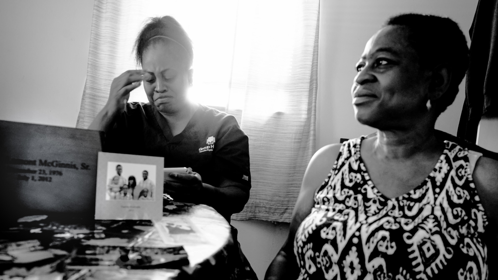 Lisa and Yolanda McGinnis, the niece and sister of Corey McGinnis, who died after being shocked with a taser by police in 2012 [Josh Rushing/Al Jazeera]