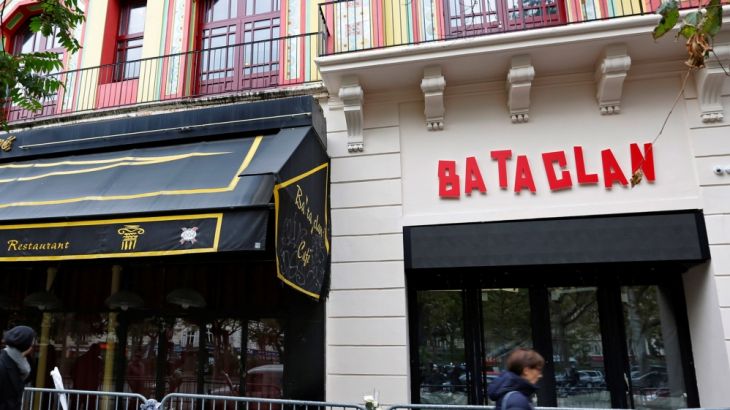 People walk past the Bataclan Cafe and the new facade of the Bataclan concert hall almost one year after a series of attacks at several sites in Paris