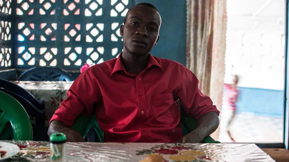 Patrick is proud to have played a role in the fight against Ebola, but he suffers from flashbacks of when he was a burial worker [Olivia Acland/Al Jazeera] 