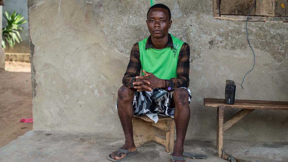 Hassan, 17, suffers from mental health problems resulting from the loss of his parents to Ebola [Olivia Acland/Al Jazeera]