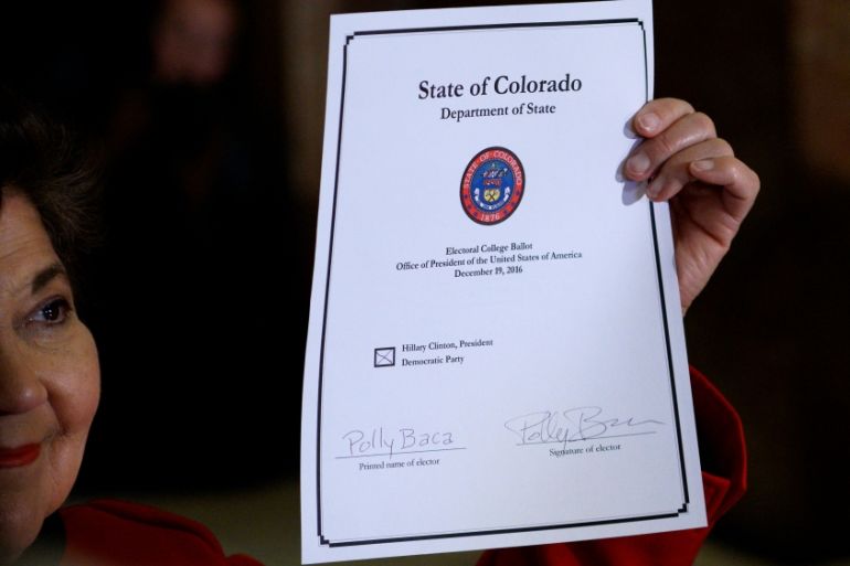 Colorado Electoral College elector Sen. Polly Baca displays her voted ballot after voting at the State Capitol in Denver