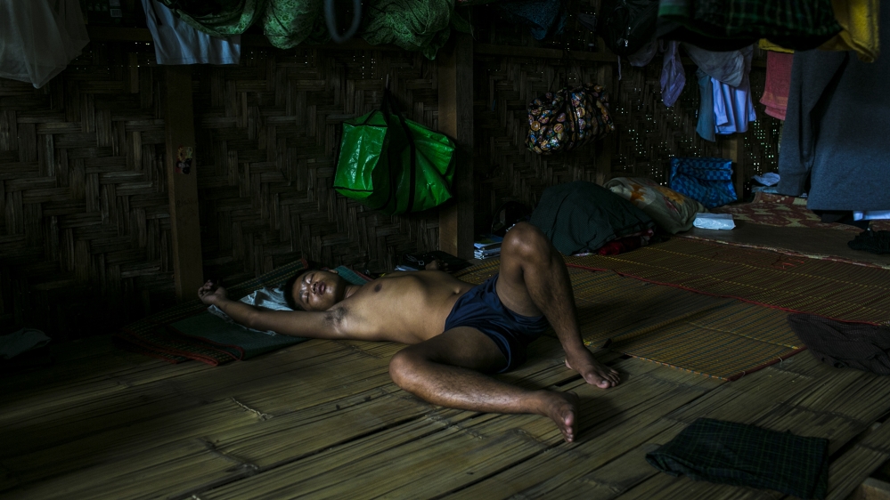 A client rests in the shared bamboo accommodation of the New Life in Christ Centre [David Shaw/Al Jazeera]