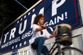 An Israeli cyclist passes a placard proclaiming 'Trump Make Israel Great Again' in Tel Aviv, Israel on November 12, 2016 [Jim Hollander/EPA]

 [EPA]