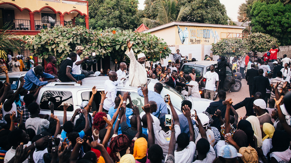 President-elect Adama Barrow waves to his supporters outside his residence [Misha Somerville/Al Jazeera]