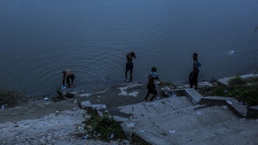 Local Kachin people wash in the Irrawaddy river on the banks of Myitkyina [David Shaw/Al Jazeera]