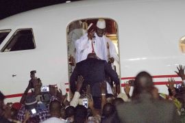 Gambia's defeated leader Yahya Jammeh waves to supporters as he departs at Banjul airport Saturday Jan 21, 2017 [AP] 