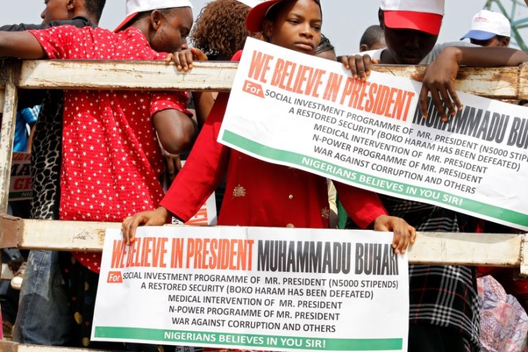 People hold placards during a rally to show support for Nigeria''s President Muhammadu Buhari in Abuja