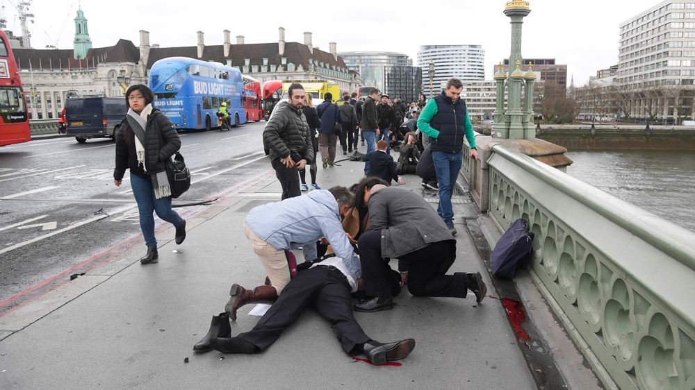 Injured people are assisted after the attack on Westminster Bridge [Toby Melville/Reuters]