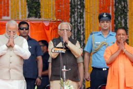 PM Narendra Modi, Uttar Pradesh governor Naik and India’s ruling BJP leader Adityanath greet a gathering before Adityanath takes an oath as the new Chief Minister of India’s most populous state of Utt