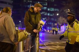 People leave flowers at the scene after an attack on Westminster Bridge in London