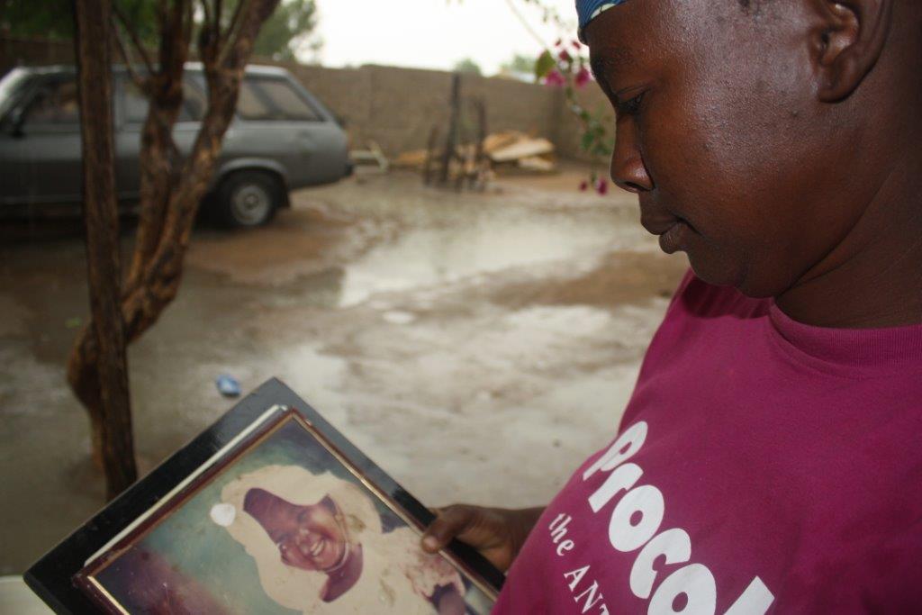 Esther Yakubu looks at a photo of her daughter Dorcas, who remains missing and appeared in a Boko Haram video last year [Chika Oduah/Al Jazeera]