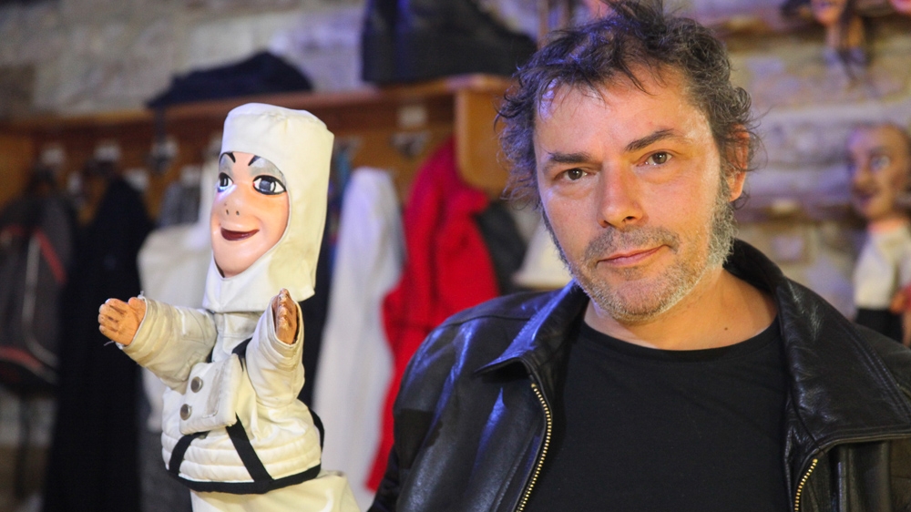 Over his career as a puppeteer, Philippe Secle says he's played all the traditional Guignol roles, including Guignol himself. [Allison Griner/Al Jazeera]