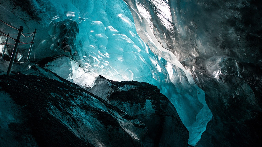 Ice caves form inside glaciers, giving visitors a unique perspective of Falljokull's inner structure. Guides say the ice caves never survive the summer months [Alexander Lerche/Al Jazeera]