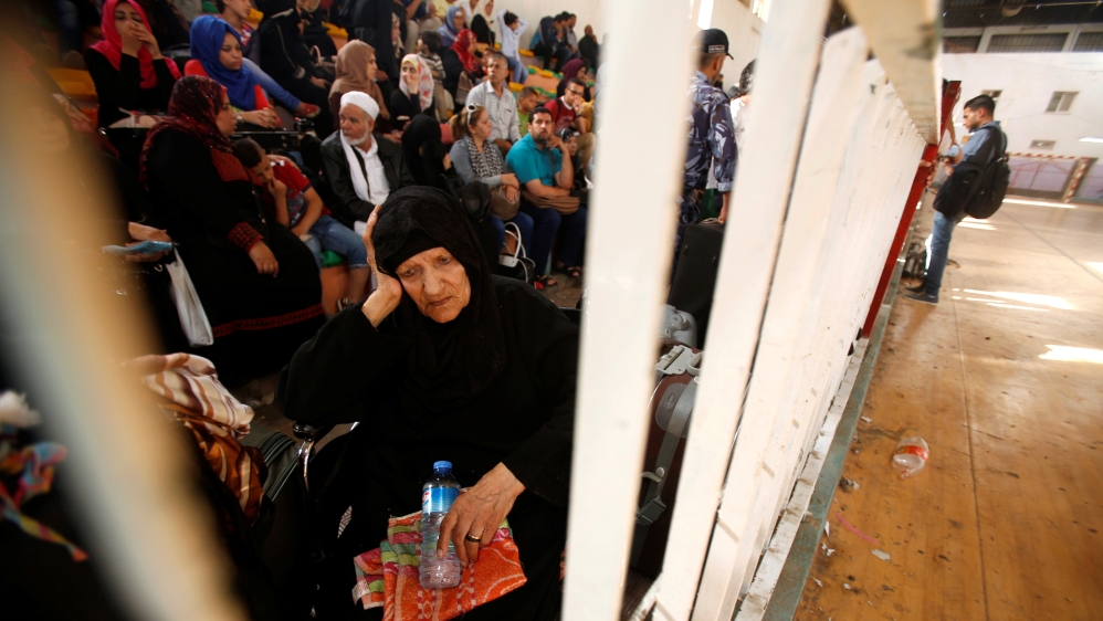 A woman waits for a travel permit to cross into Egypt through the Rafah border crossing after it was opened for four days by Egyptian authorities, in the southern Gaza Strip June 1, 2016 [Reuters]