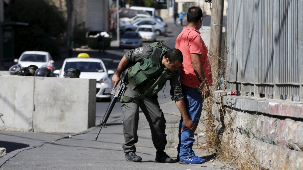 Palestinians are subject to random and often humiliating body searches by Israeli soldiers on the streets of occupied East Jerusalem [Reuters]