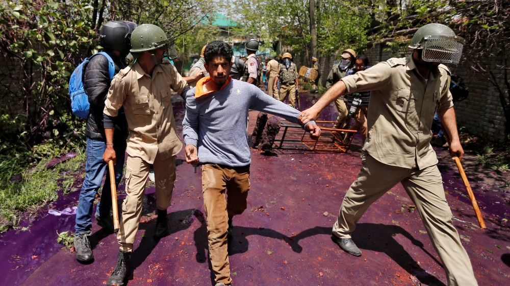 Indian policemen detain a Kashmiri student during a protest in Srinagar April 24, 2017 [Danish Ismail/Reuters]