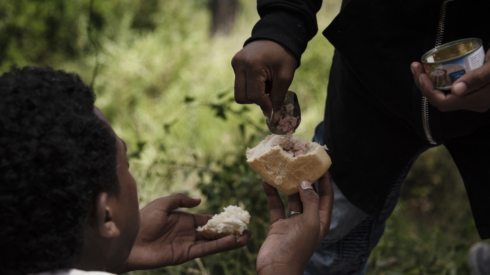 The boys eat bread and tuna before hiking to the summit [Maurizio Martorana/Al Jazeera]