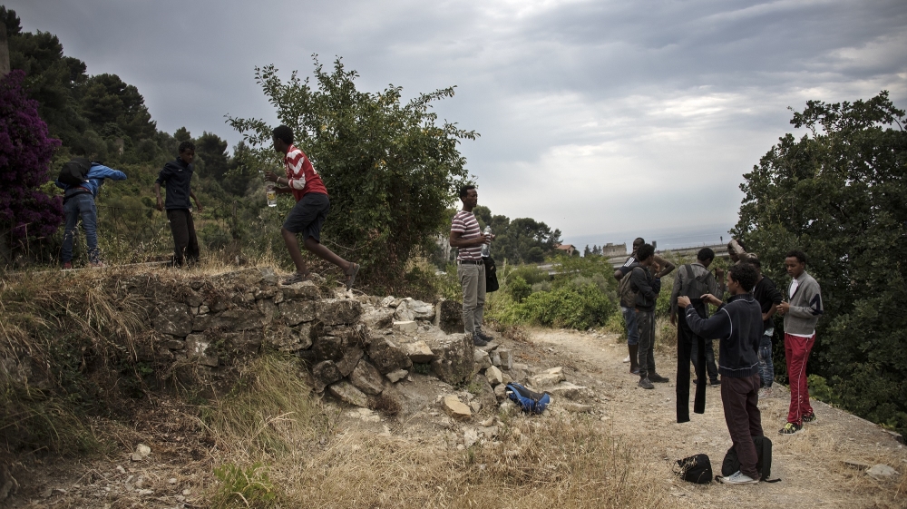 The boys fill water bottles at a farmhouse before beginning the Pass of Death [Maurizio Martorana/Al Jazeera]