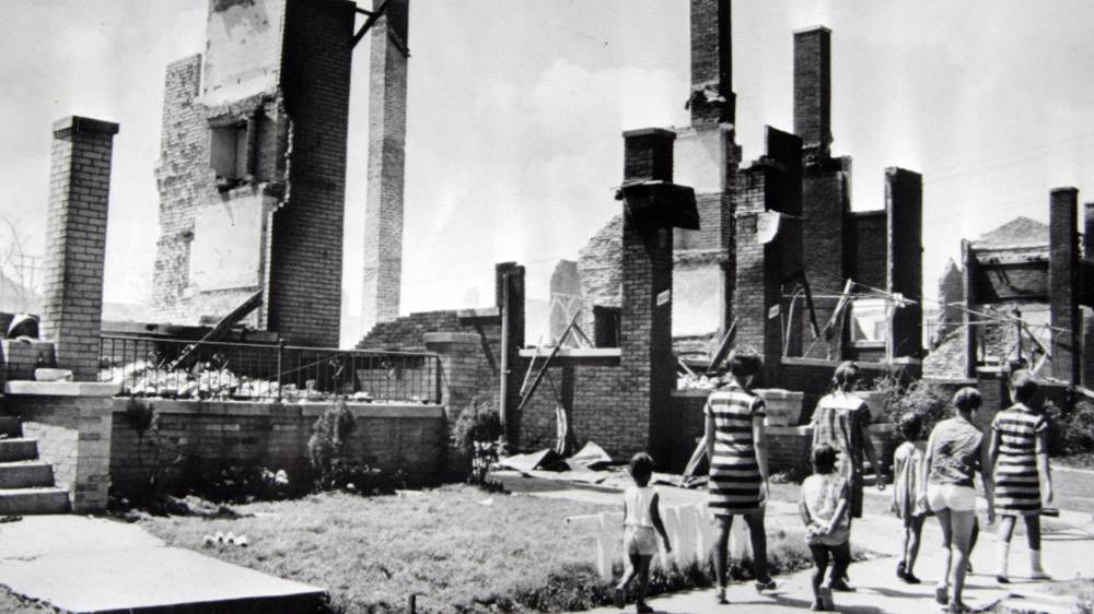 Women and children stroll past the burned remains of homes after riots in Detroit on July 23. The houses were a short distance from 12th Street, centre of the riot activity. After the riots, a decline that had already begun would accelerate; Detroit was the nation's fourth-biggest city in 1960, but would rank 21st by 2016. The middle class fled, and a proud city fell into poverty, crime and hopelessness. [File: The Associated Press]