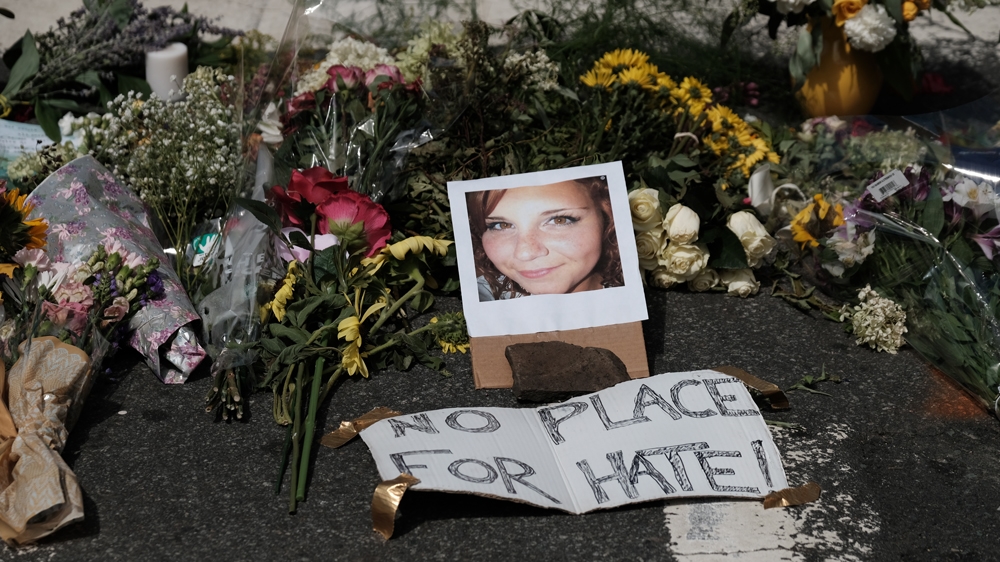Flowers and a photo of car ramming victim Heather Heyer lie at a makeshift memorial in Charlottesville [Justin Ide/Reuters]