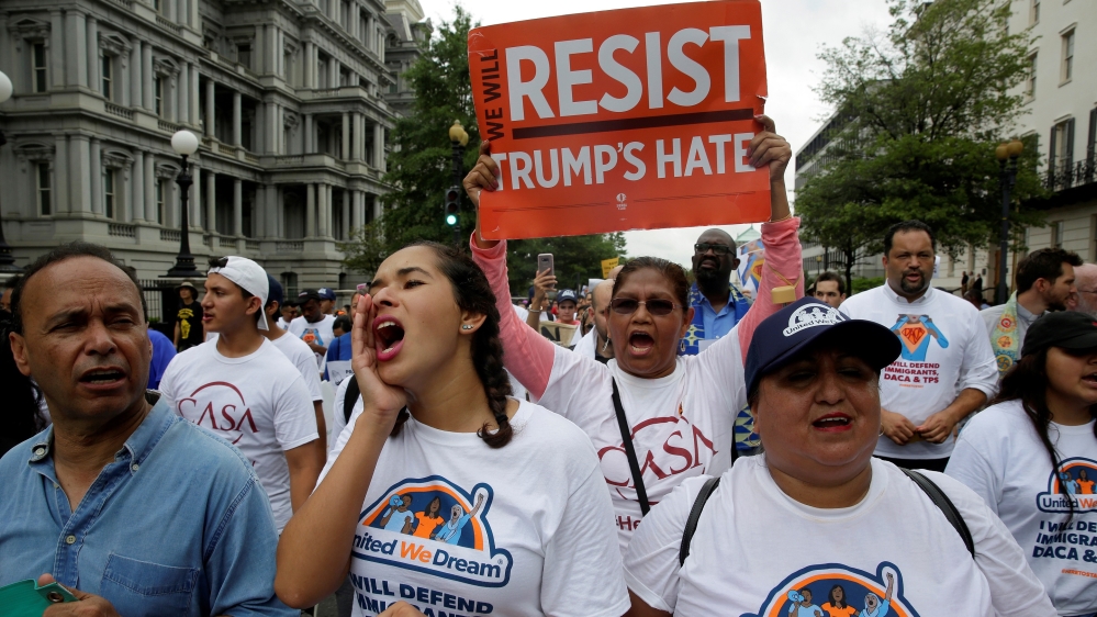 Demonstrators march to demand the Trump administration protect the Deferred Action for Childhood Arrivals (DACA) and the Temporary Protection Status (TPS) programmes [Joshua Roberts/Reuters]