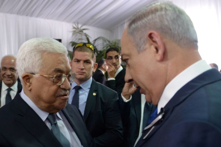 Israeli PM Netanyahu shakes hands with Palestinian President Abbas during funeral of former Israeli President Shimon Peres in Jerusalem