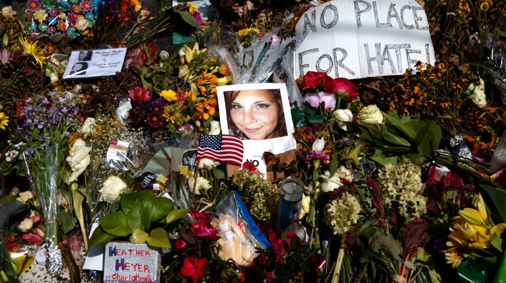 A photo of Heather Heyer, who was killed during a white nationalist rally, sits on the ground at a memorial in Charlottesville, Virginia [Evan Vucci/AP Photo]
