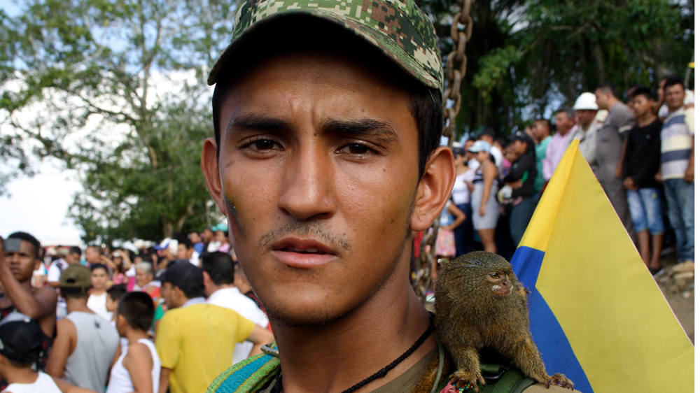 Members of the FARC made their journey towards the demobilisation zone carrying their pets such as dogs, birds, and titi monkeys [Chantal Flores/Al Jazeera]