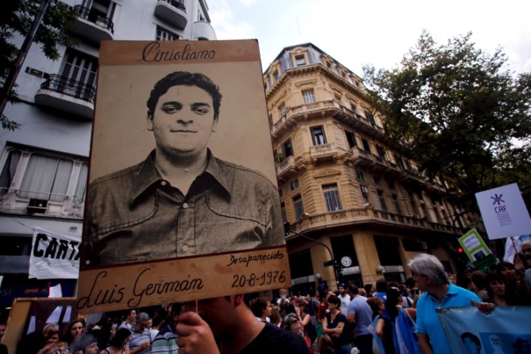 A man holds up a portrait of a man who disappeared during Argentina''s ''Dirty war'' during a demonstration to commemorate the 40th anniversary of the 1976 military coup in Buenos Aires