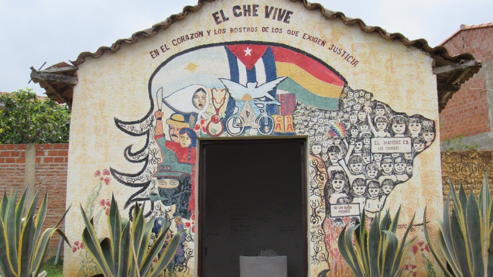 The laundry room in Vallegrande where Che's body was displayed. The sign above the door reads, 'Che lives on in the hearts and faces of those who demand justice' [Linda Farthing/Al Jazeera] 