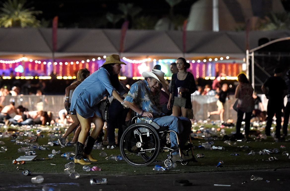 LAS VEGAS, NV - OCTOBER 01: A man in a wheelchair is taken away from the Route 91 Harvest country music festival after apparent gun fire was heard on October 1, 2017 in Las Vegas, Nevada. There are re