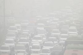 Vehicles drive through heavy smog in Delhi