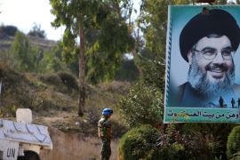 A U.N peacekeepers of the United Nations Interim Force in Lebanon (UNIFIL) stands near a poster depicting Lebanon''s Hezbollah leader Sayyed Hassan Nasrallah in Adaisseh in southern Lebanon