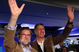 Spanish Prime Minister Mariano Rajoy and Catalan People''s Party (PP) president Xavier Garcia Albiol wave as they arrive at a Catalan regional People''s Party meeting in Barcelona