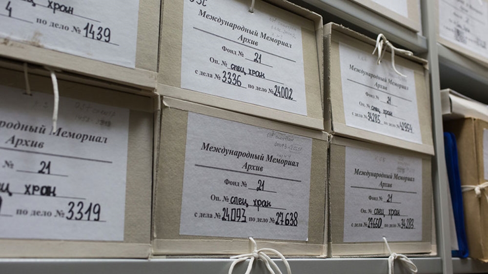 Boxes of case files at the Memorial organisation, an NGO that focuses on recording and publicising past Soviet political repressions [Andrew Kovalenko/Al Jazeera]