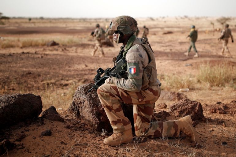 Troops from the Malian Armed Forces and French soldiers conduct a joint patrol during the regional Operation Barkhane in Inaloglog, Mali