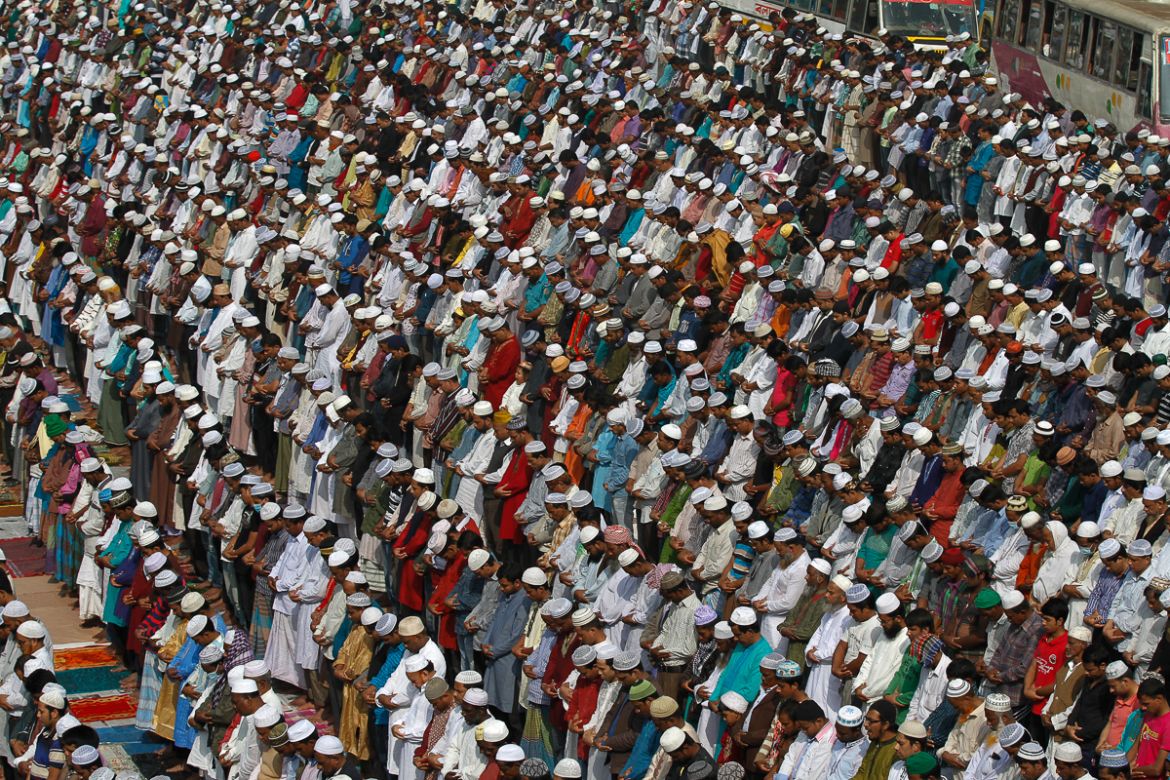 Muslim devotees attend Friday prayers in the streets near the congregation grounds. [Mahmud Hossain Opu/Al Jazeera]