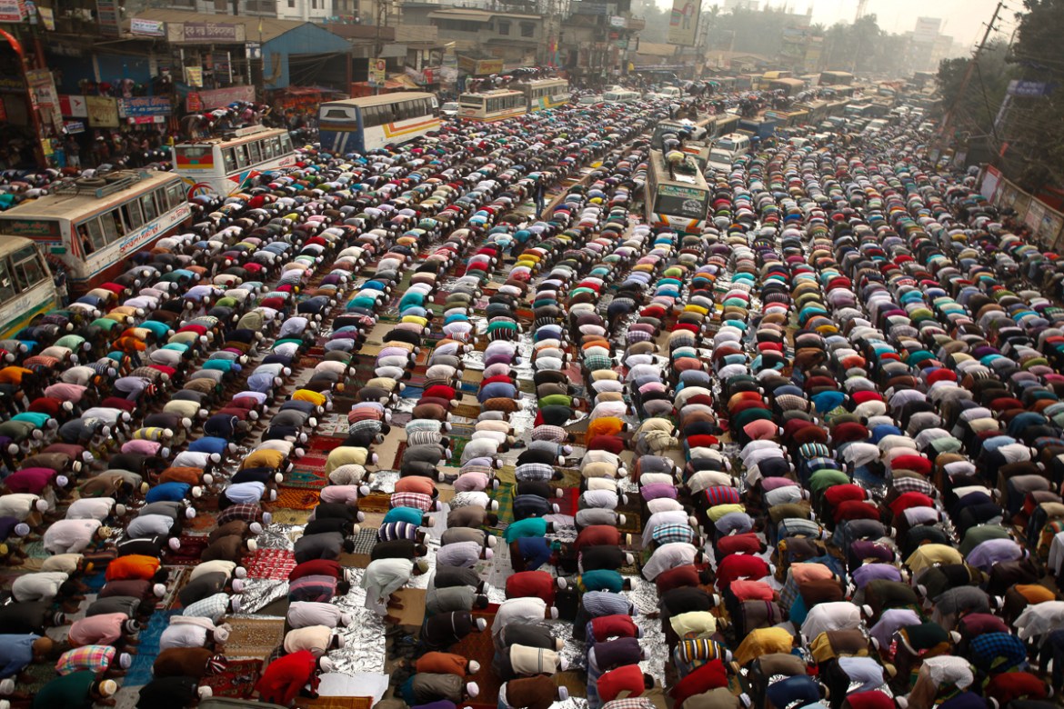 Muslim devotees attend prayers in the streets near the congregation grounds at Turag. [Mahmud Hossain Opu/Al Jazeera]