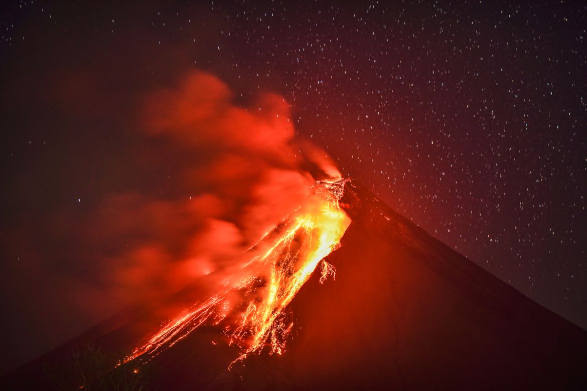 Lava flows down the slope of Mount Mayon as seen from Legazpi, Albay province, Philippines, on the evening of January 23, 2018. The Philippines, which currently has 23 active volcanoes, sits in the Pa