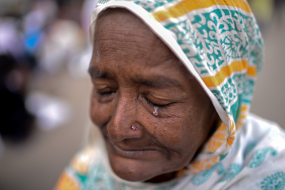 A devotee cries as he prays during "Bishwa Ijtema", the world congregation of Muslims. [Mahmud Hossain Opu/Al Jazeera]