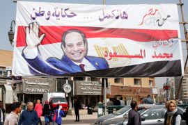 People walk by a poster of Egypt''s President Abdel Fattah al-Sisi for the upcoming presidential election, in Cairo