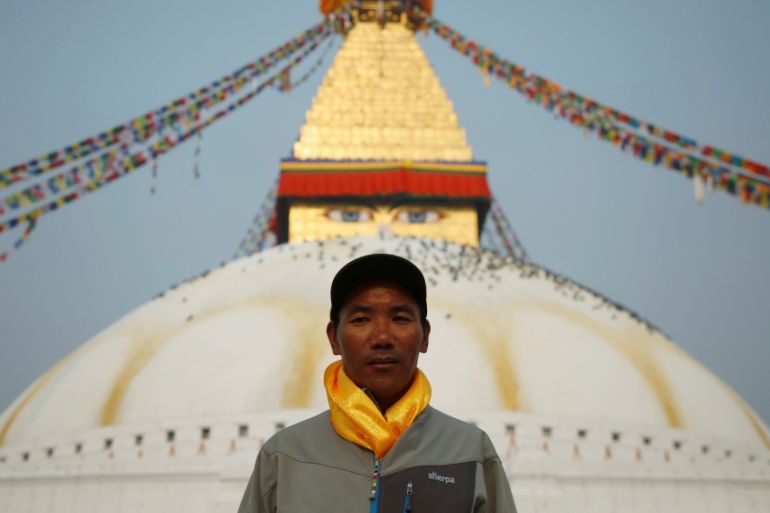 Kami Rita Sherpa, 48, who is attempting a world record by climbing Mount Everest for the 22nd time this season, poses for a picture at Boudhanath Stupa in Kathmandu