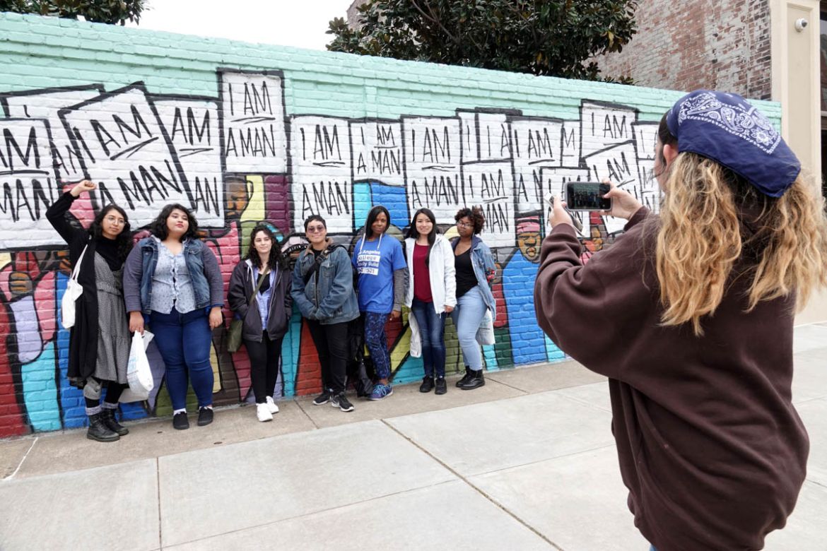 Visitors pose with an I Am A Man mural near the National Civil Rights Museum in Memphis during events surrounding the 50th anniversary of the death of civil rights leader Martin Luther King Jr. in Mem
