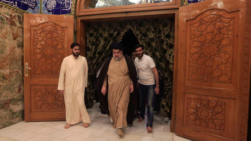 Shia leader Muqtada al-Sadr visited his father's grave after the parliamentary election results were announced, in Najaf, on May 14 [Alaa al-Marjani/Reuters]