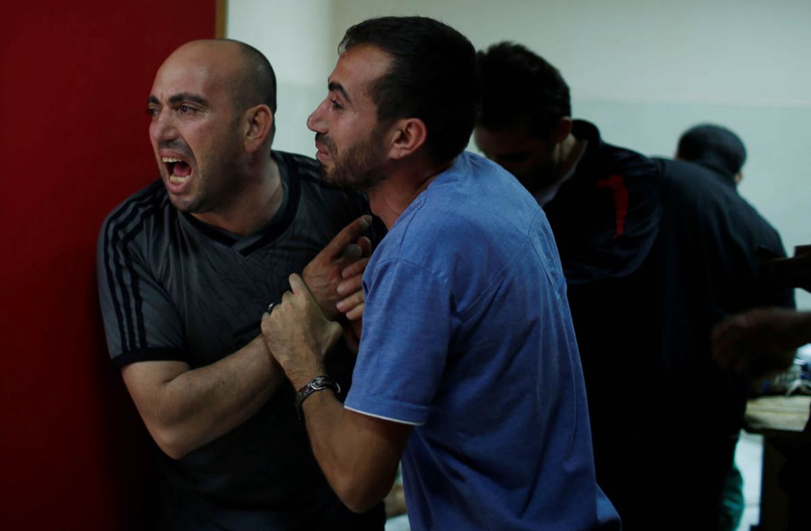 Relatives of a Palestinian, who was killed during a protest at the Israel-Gaza border, react at a hospital in the northern Gaza Strip May 14, 2018. REUTERS/Mohammed Salem