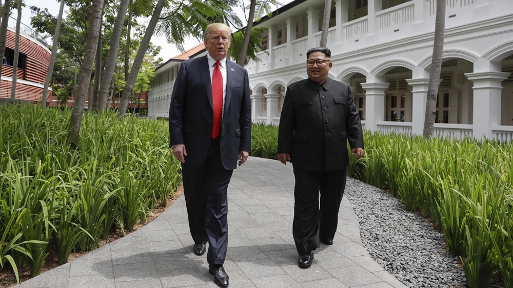 Trump and Kim take a short stroll after lunch [Evan Vucci/The Associated Press]