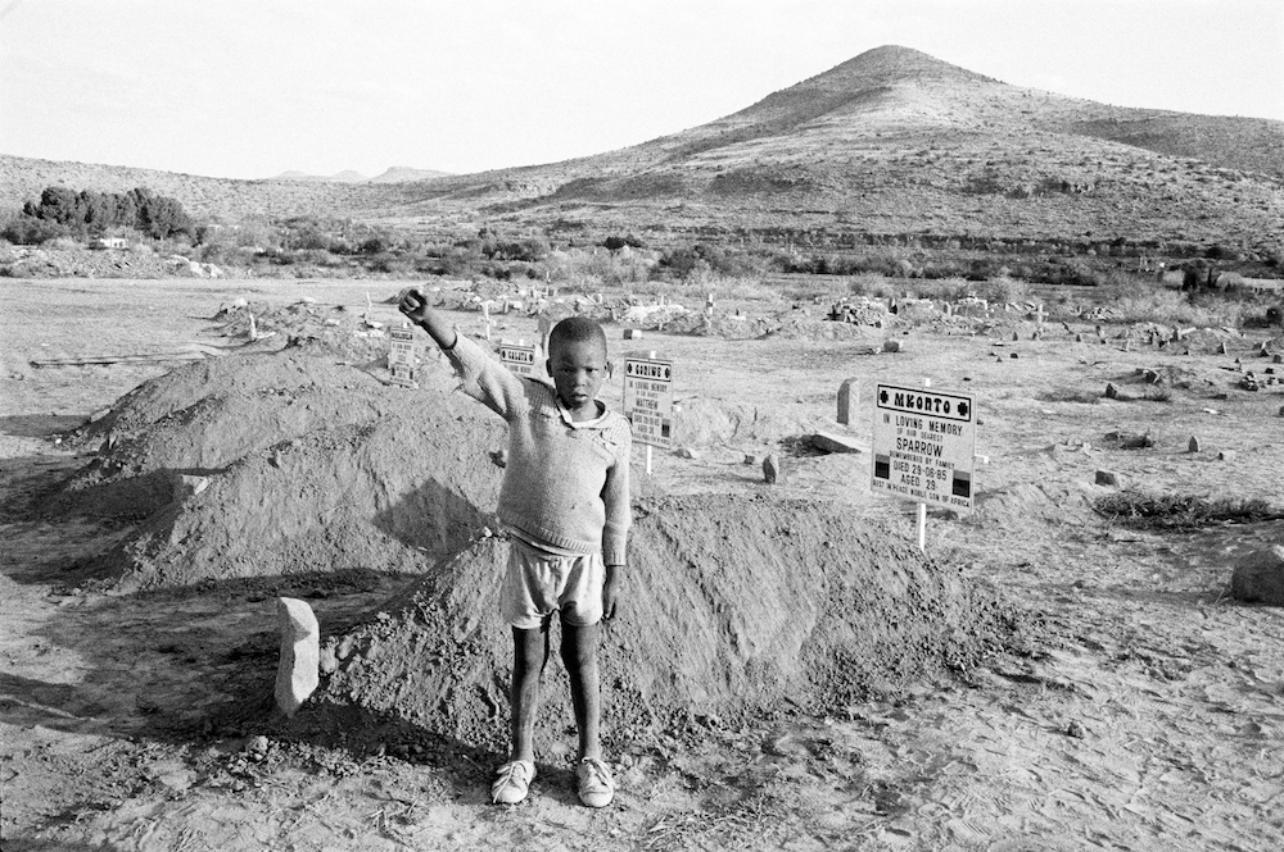 After their funeral, a child salutes the Cradock Four, Cradock, Eastern Cape, 20 July 19851985 [Photograph by David Goldblatt]